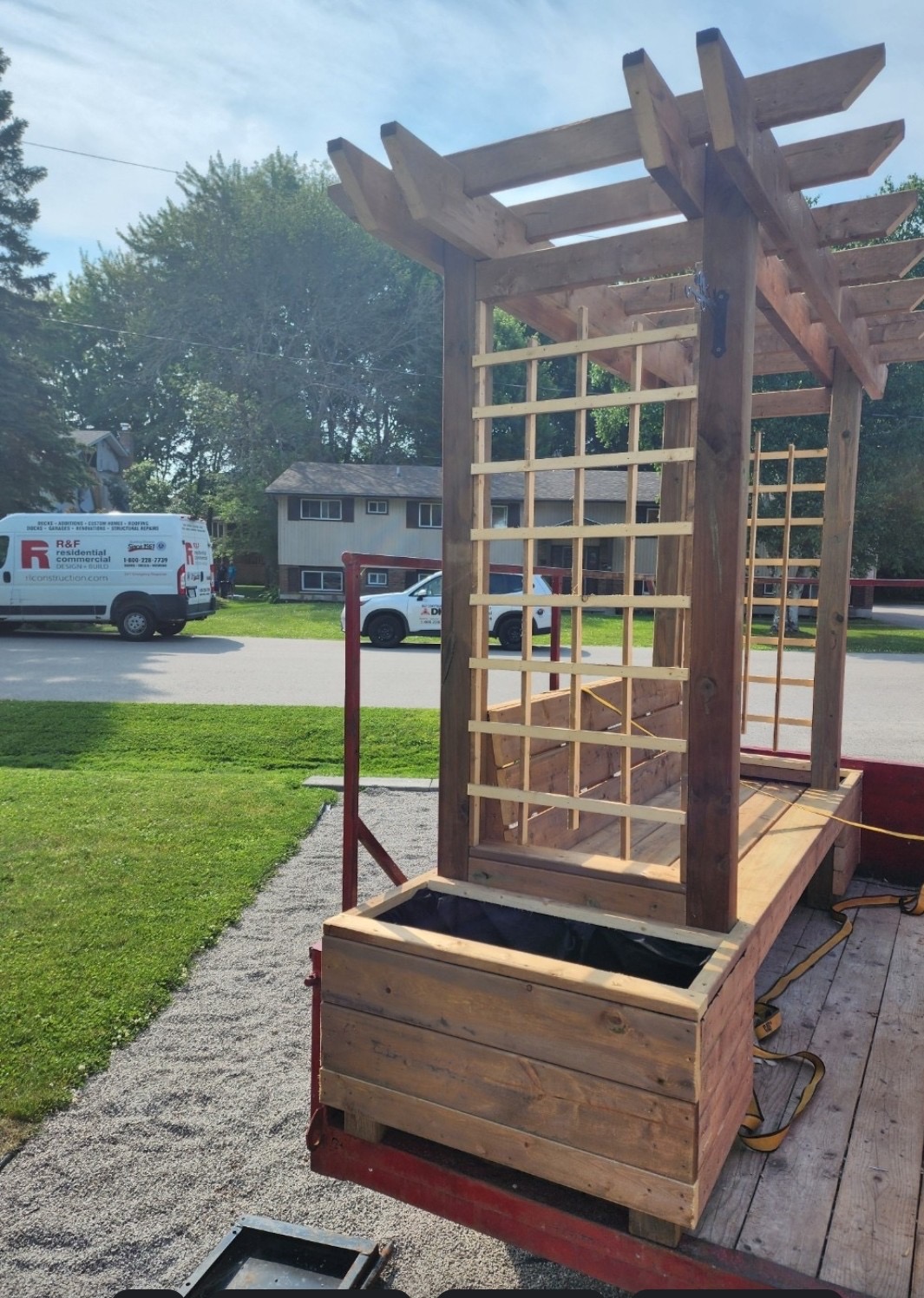 Custom-built cedar pergola bench with trellis and integrated planter box