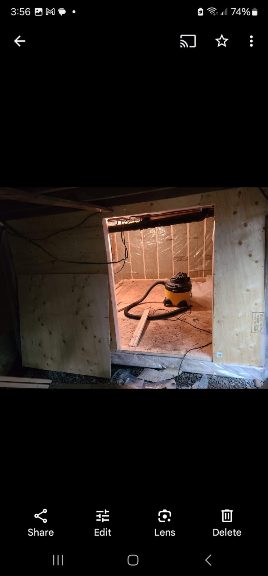 Framed plywood doorway leading into a basement room under construction