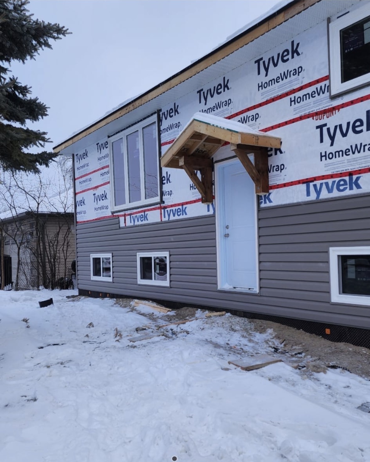 House siding and weather barrier installation in winter
