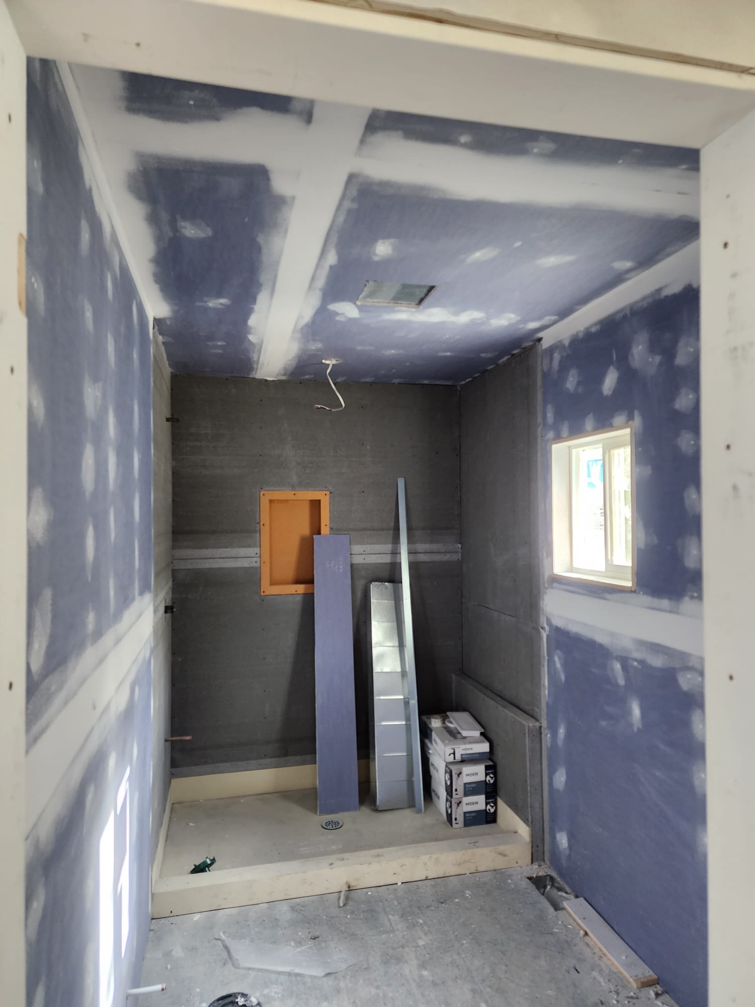 New shower room addition with moisture-resistant drywall and plumbing niche