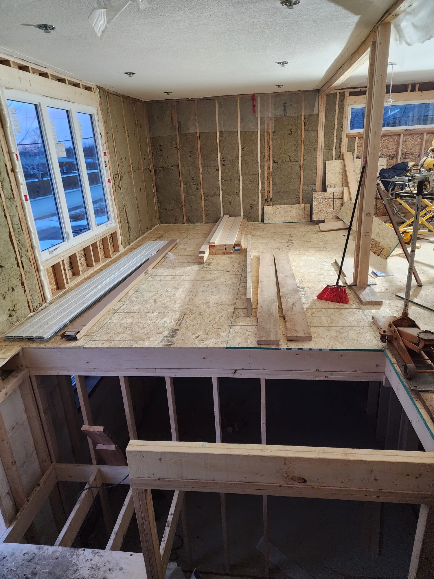 Upper level room framing with new window openings and subfloor installed
