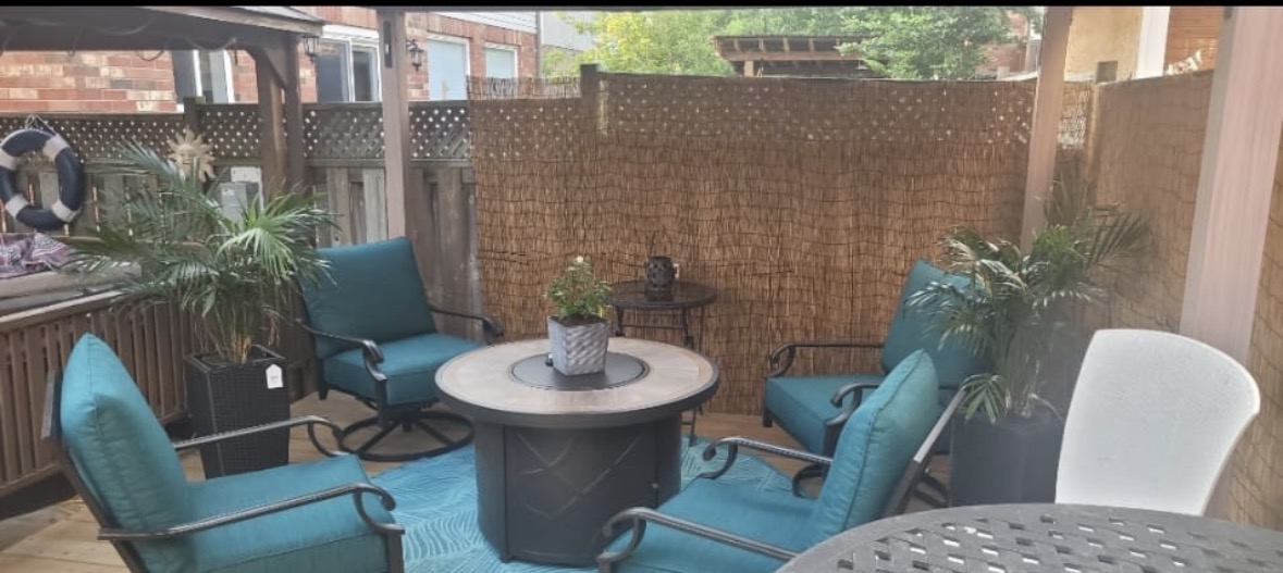 Deck lounge with fire pit and teal chairs