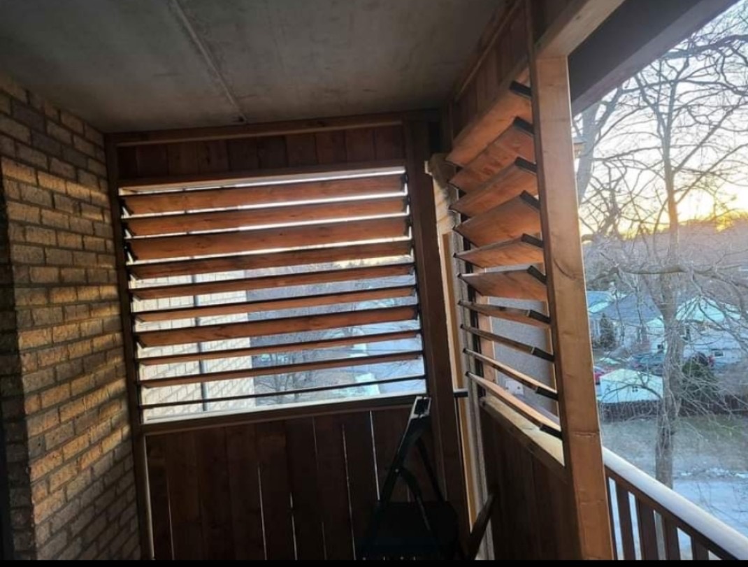 Cedar louvered privacy wall built into a covered porch