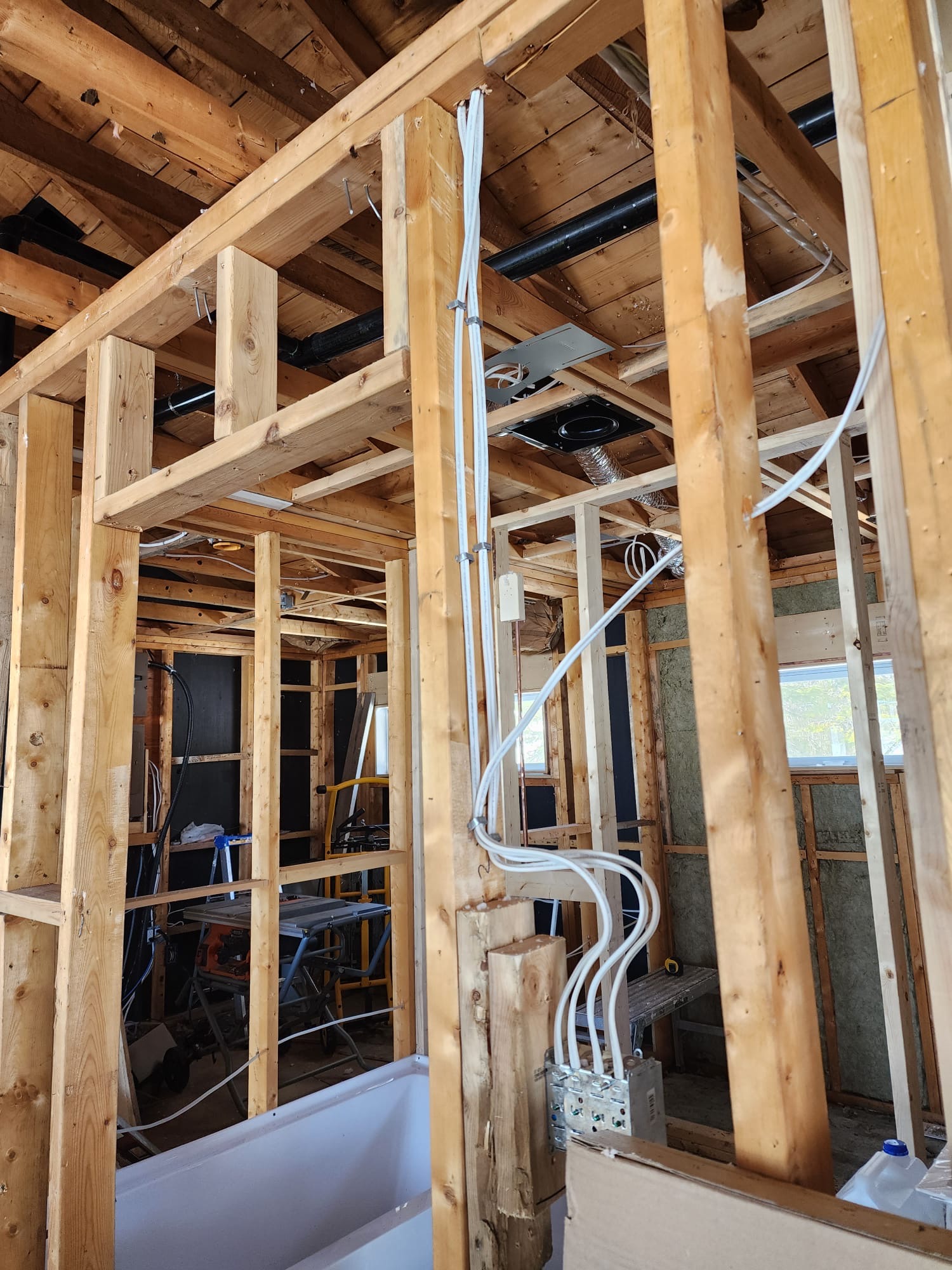 Interior wall framing with new electrical wiring and ventilation rough-in