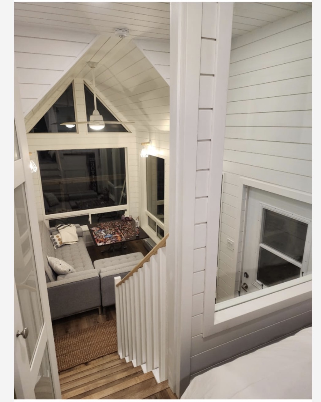 Finished sunroom with vaulted shiplap ceiling at night