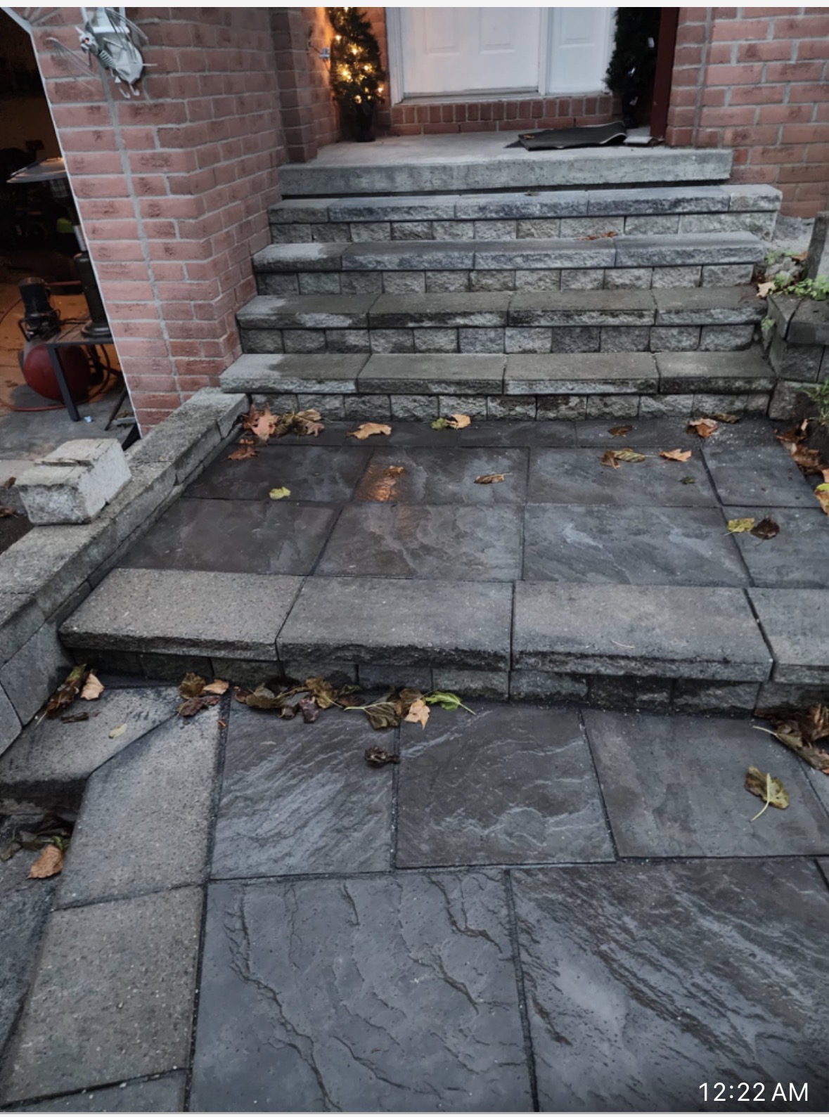 Completed front entrance stone steps and landing with dark grey pavers