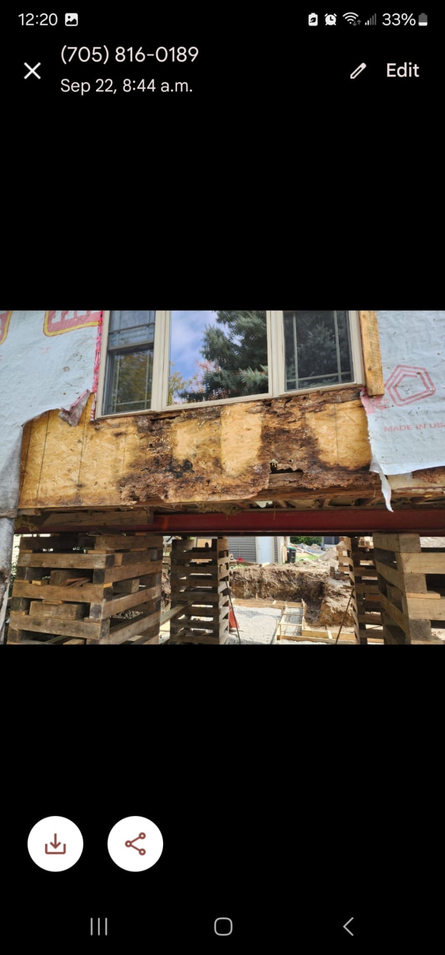 Exterior wall restoration with damaged sheathing removed and wall supported on pallets